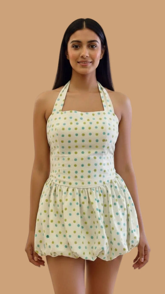 Woman wearing a polka dot dress on a beige background